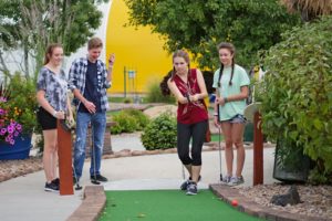 Four Guests Playing Mini Golf Four Guests Playing Mini Golf